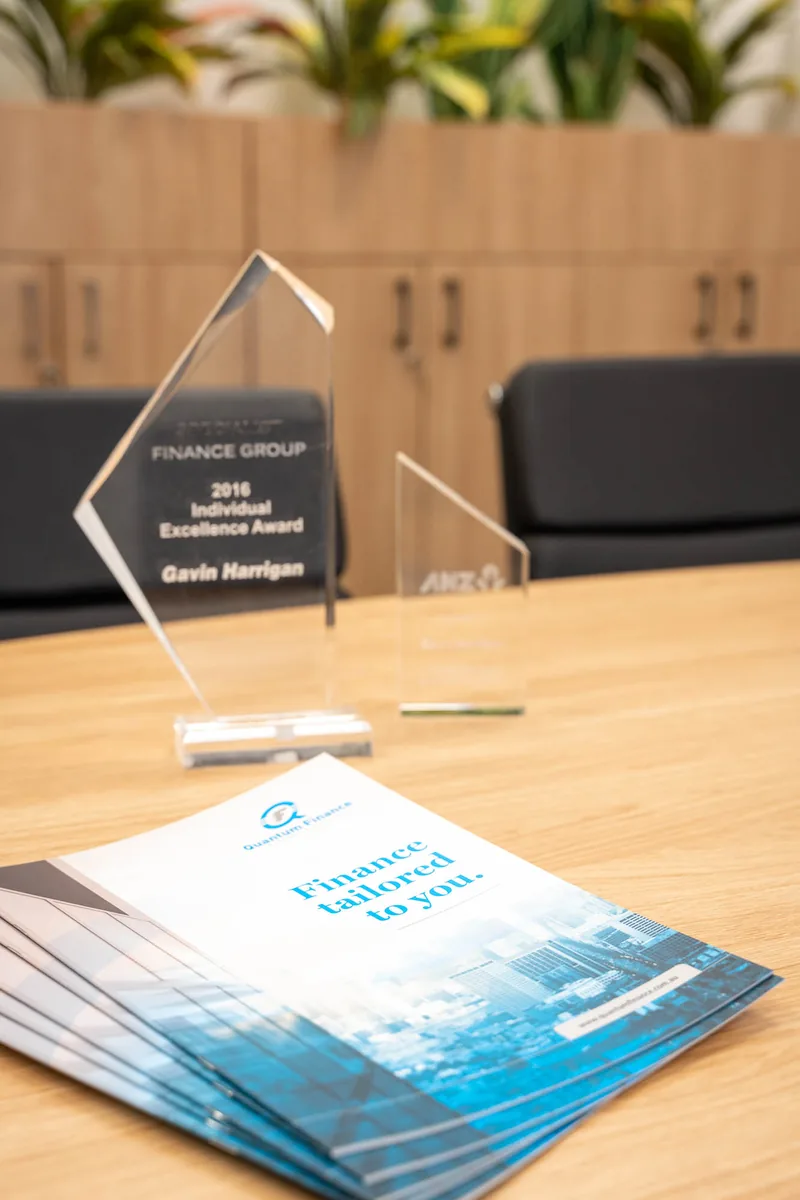 An award and Quantum Finance brochures on a desk at the West Leederville office