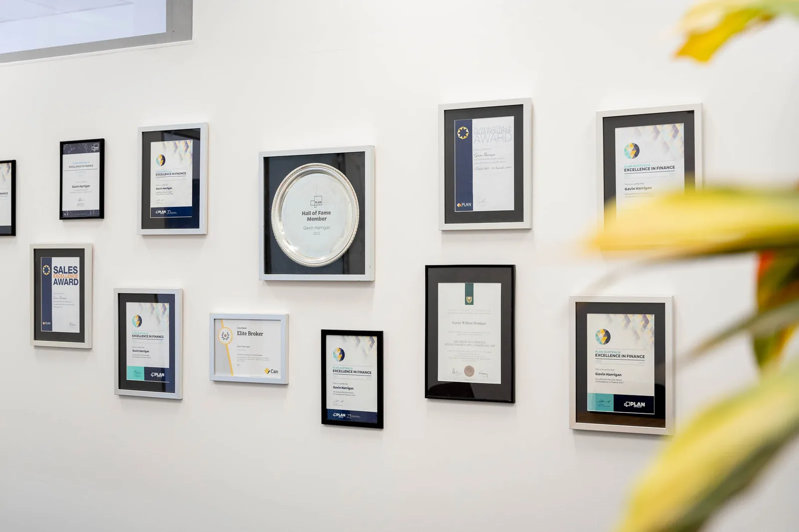 Framed industry award certificates and the PLAN Australia Hall of Fame salver on the wall at the Quantum Finance Australia office