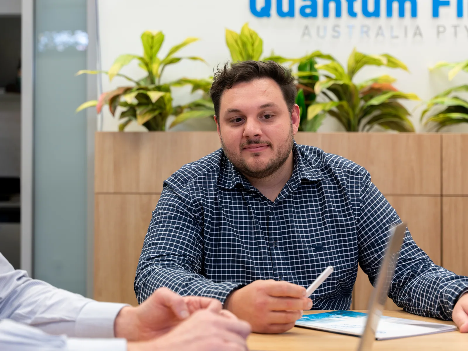 A Quantum Finance broker going through development funding documents with a client