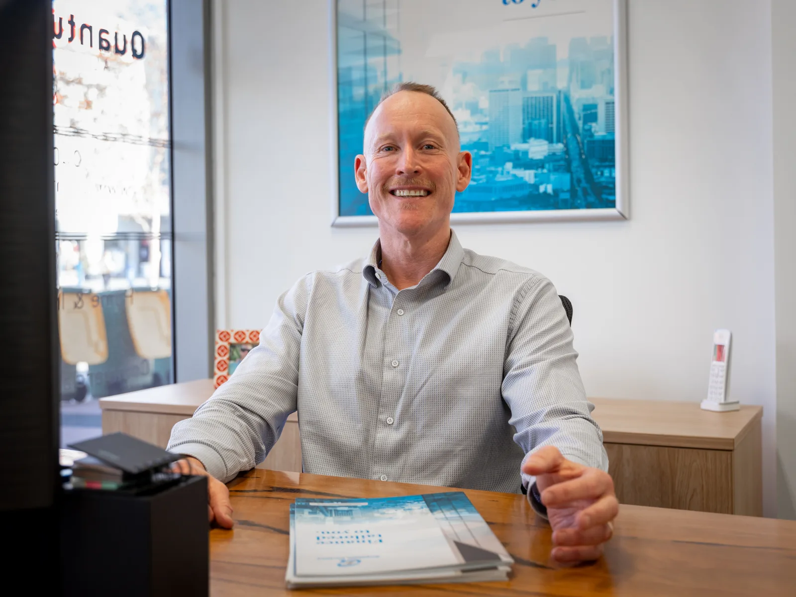 Gavin Harrigan reviewing a client's existing home loan at his desk