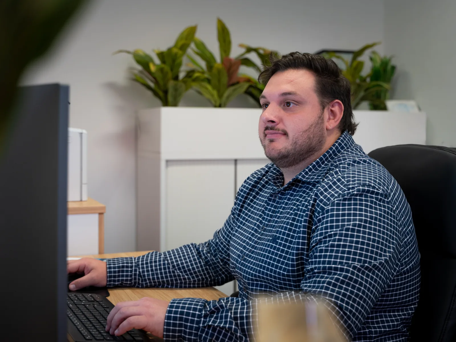 A Quantum Finance broker checking a construction file against the building contract