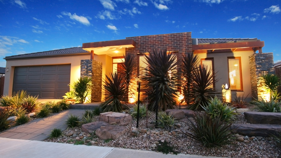 A lit up Australian home in the evening