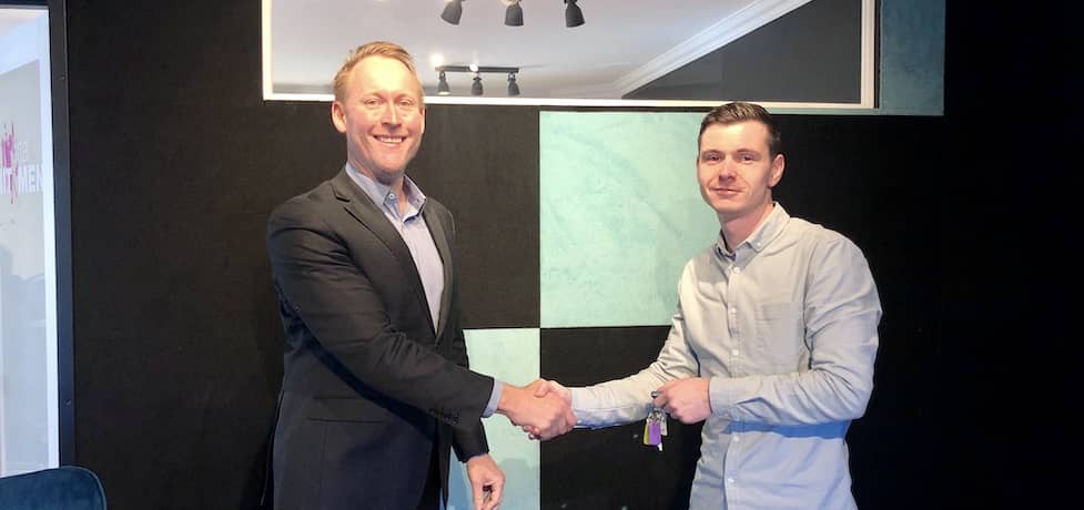 Gavin shaking hands with a client over a home loan.