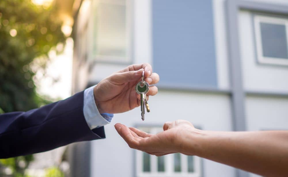 Seller giving keys to home buyer.