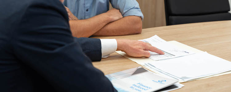 Gavin Harrigan pointing at a document showing current home loan industry trends